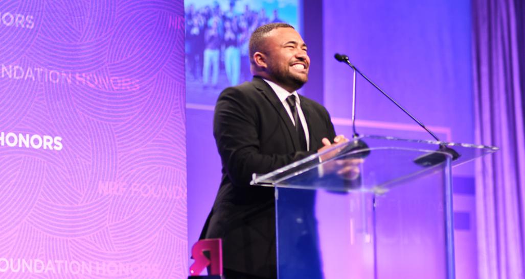 John-Martin Rigsby at the podium onstage at the 2022 NRF Foundation Honors